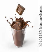 Chocolate blocks falling into a glass splashing. Chocolate blocks falling into a glass splashing.