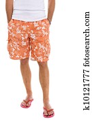 Closeup on legs of male in shorts and flip flops