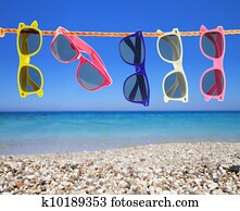 Collection of sunglasses on the beach