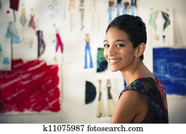 Confident entrepreneur, portrait of happy hispanic young woman working as fashion designer and dressmaker in atelier Confident entrepreneur, portrait of happy hispanic young woman working as fashion designer and dressmaker in atelier