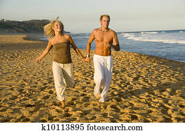 Couple running at beach