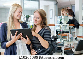 Customer With Hairdresser Holding Digital Tablet