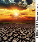 dramatic sunset over drought land