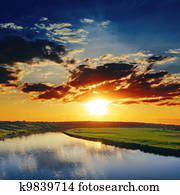 dramatic sunset over river