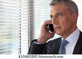 Executive phone in front of window Executive phone in front of window