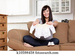 Expecting Mother with Baby Clothes