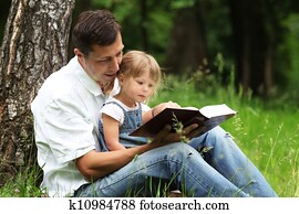 father and daughter reads the Bible father and daughter reads the Bible