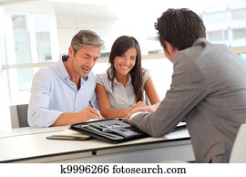 Father and teenager signing loan contract