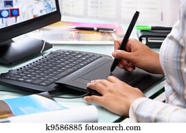 Female graphic designer using tablet pen Female graphic designer using tablet pen