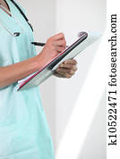 Female nurse holding clipboard and pen