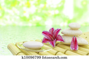 Flowers stones and soap near water in spa salon Flowers stones and soap near water in spa salon