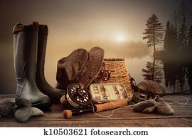 Fly fishing equipment on deck with view of a misty lake Fly fishing equipment on deck with view of a misty lake