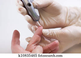 Geriatric nurse measures the blood sugar level