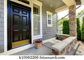 Grey house exterior with black door.