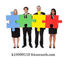 Group of business people assembling puzzle