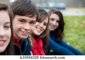 Group of Four happy teenagers outside