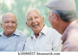 Group of happy elderly men laughing and talking