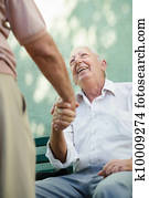 Group of happy elderly men laughing and talking