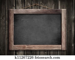 Grunge small blackboard hanging on wooden wall as a background for your message Grunge small blackboard hanging on wooden wall as a background for your message