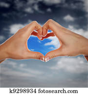 Hands and blue cloudy sky