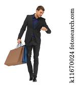 handsome man in suit with shopping bags
