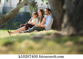 Happy family in city gardens relaxing during holidays