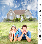 Happy family near new house.