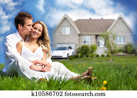 Happy family near new house.