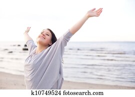 Happy Woman Stretching Her Arms to Enjoy Nature Happy Woman Stretching Her Arms to Enjoy Nature