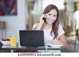 Happy woman talking to a customer Happy woman talking to a customer