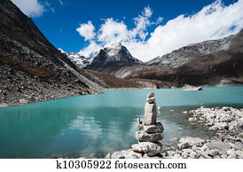 Harmony and balance: Pebble stack and Sacred Lake in Himalayas