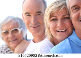 Head and shoulder shot of two mature couples