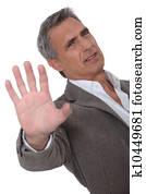 irritated man making a stop hand sign