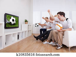Jubilant family watching television Jubilant family watching television