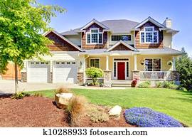 Large American beautiful house with red door.