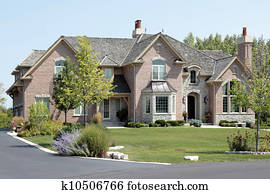Large brick home with arched entry