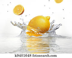 lemon splashing into clear water lemon splashing into clear water