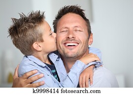 Little bond boy giving a kiss to his dad Little bond boy giving a kiss to his dad