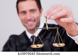 Male Judge Holding Scale Male Judge Holding Scale