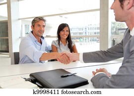 Man giving handshake to real-estate-agent