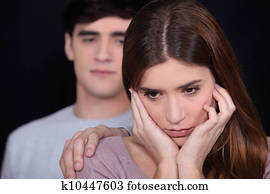 Man with his hand on a woman's shoulder