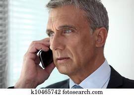 mature businessman talking on his cell