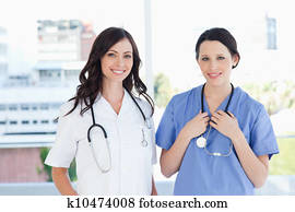 Medical interns standing upright in their short sleeve uniforms