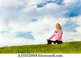 Middle-aged woman in her 40s meditating for exercise outdoors