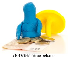 Modelling clay figure with umbrella and money