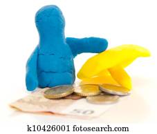 Modelling clay figure with umbrella and money
