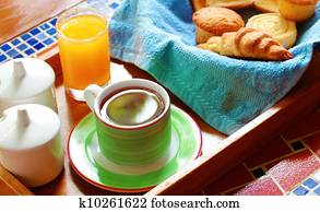 Morning wholesome breakfast or brunch on table with freshly brewed hot beverage (coffee) and continental style cuisine made of croissant, cup cakes and bread slices toasted. Morning wholesome breakfast or brunch on table with freshly brewed hot beverage (coffee) and continental style cuisine made of croissant, cup cakes and bread slices toasted.