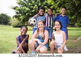 Multiethnic group of happy male friends with soccer ball Multiethnic group of happy male friends with soccer ball