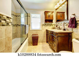 Nice bathroom with natural stone tiles and wood cabinet. Nice bathroom with natural stone tiles and wood cabinet.