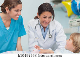 Nurse and doctor smiling to a child